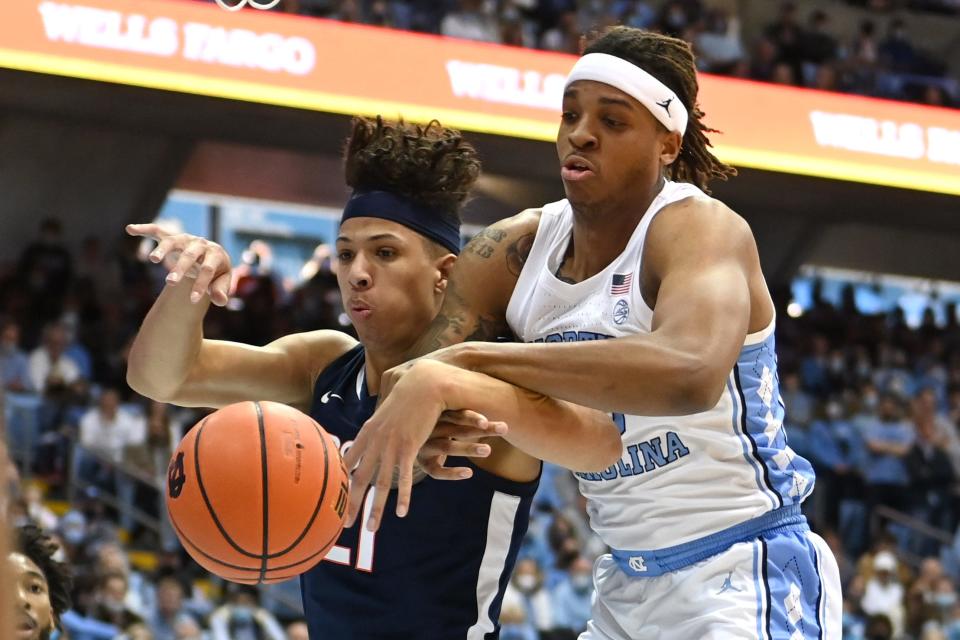 North Carolina forward Armando Bacot, right, and Virginia forward Kadin Shedrick tangle for a loose ball during the only regular-season meeting between the teams on Jan. 8 in Chapel Hill.