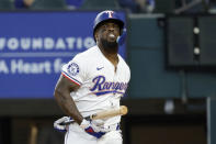 Texas Rangers outfielder Adolis García reacts after a follow through of a strike from the Oakland Athletics during the fourth inning of a baseball game Thursday, April 11, 2024, in Arlington, Texas. (AP Photo/Michael Ainsworth)