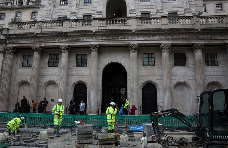 FILE PHOTO: Road construction workers carry out work outside the Bank of England in the City of London financial district