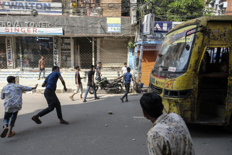 Bangladeshi garment workers vandalize buses during a protest demanding an increase in their wages at Mirpur in Dhaka, Bangladesh, Tuesday, Oct.31, 2023. (AP Photo/Mahmud Hossain Opu)