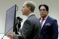Defense attorney Lorne Berkeley, left, representing NFL free agent Antonio Brown addresses the court as defense attorney Eric Schwartzreich, right, listens during a first appearance hearing, Friday, Jan. 2,4 0202, at the Broward County Courthouse in Fort Lauderdale, Fla. Brown was granted bail on Friday after turning himself in at a Florida jail on charges that he and his trainer attacked the driver of a moving truck that carried some of his possessions from California. (Amy Beth Bennett/South Florida Sun Sentinel via AP, Pool)