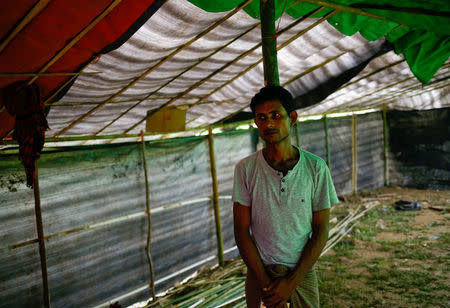Bodi Alom, 28, a Rohingya refugee who found his mother and brother's dead bodies after military swept through the Kha Maung Seik village of Myanmar, poses for a picture in Cox’s Bazar, Bangladesh, September 4, 2017. REUTERS/Mohammad Ponir Hossain