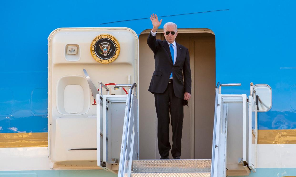 <span>Joe Biden waves from Air Force One after the US-Russia summit with Vladimir Putin on 16 June 2021.</span><span>Photograph: Martial Trezzini/AFP/Getty Images</span>