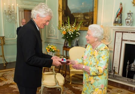 FILE PHOTO: Britain's Queen Elizabeth presents James Dyson with the insignia of members of the Order of Merit, at Buckingham Palace, London