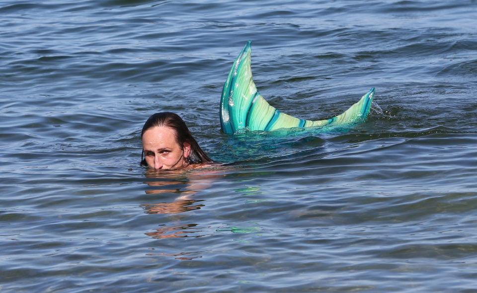 Mermaid Lavinia swims in the Atlantic Ocean at Wells Beach after sunning herself on the jetty Aug. 23, 2023.