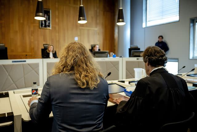 <p>Hollandse Hoogte/Shutterstock</p> Jonathan Meijer and his lawyer Richard van der Zwan take their seats in court on April 13, 2023.