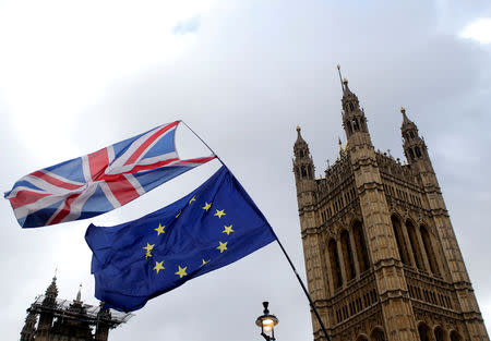 FILE PHOTO: Flags flutter outside the Houses of Parliament, ahead of a Brexit vote, in London, Britain March 13, 2019. REUTERS/Tom Jacobs/File Photo