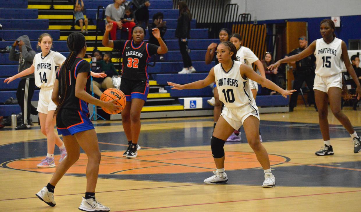 Palm Beach Garden's Brandi Brown positions to pass the ball to Latasha Whyte against Dwyer on Feb. 1, 2024.
