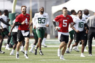 New York Jets quarterbacks James Morgan (4) and Mike White (5) warm up during NFL football practice Wednesday, July 28, 2021, in Florham Park, N.J. (AP Photo/Adam Hunger)