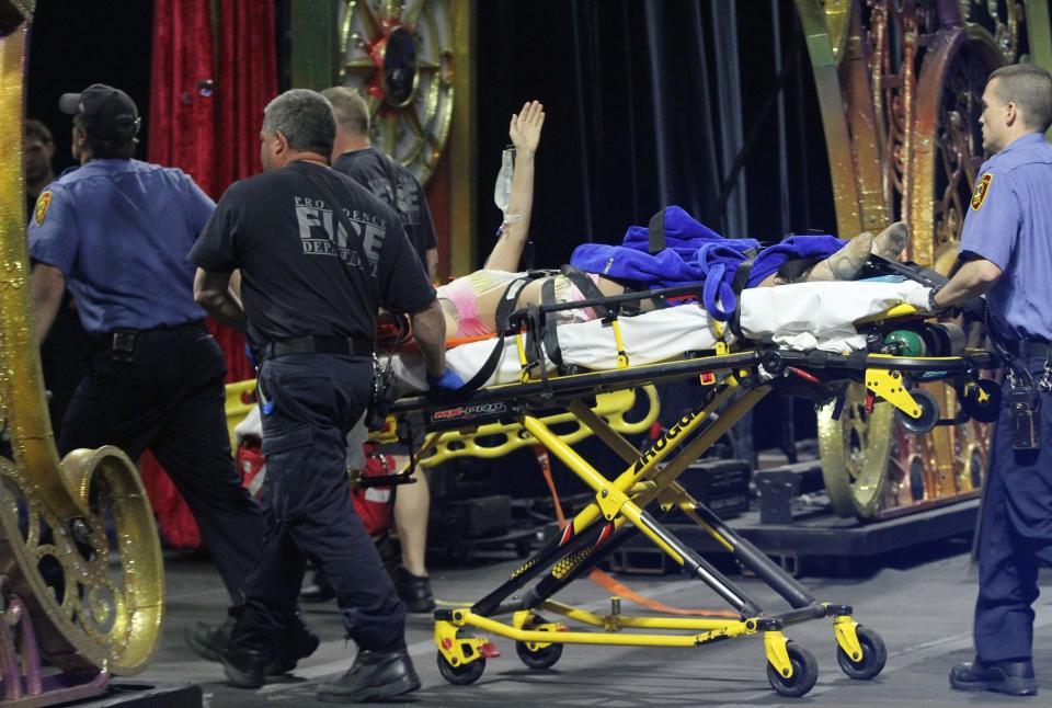 An injured female circus performer waves to the crowd as she is taken from the ring on a stretcher following a fall during a performance in 2014 at the Dunkin' Donuts Center in Providence.  