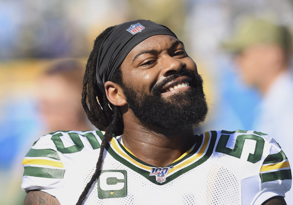 FILE - In this Sunday, Nov. 3, 2019, file photo, Green Bay Packers linebacker Za'Darius Smith (55) smiles towards the stands and a section of Packers fans before an NFL football game against the Los Angeles Chargers in Carson, Calif. Za’Darius Smith and Preston Smith aren’t related, but the Packers pass rushers share the same last name and the same type of productive games. They combined for 25 ½ sacks last season after both signed with the Packers as free agents in early 2019. (AP Photo/John Cordes, FIler)