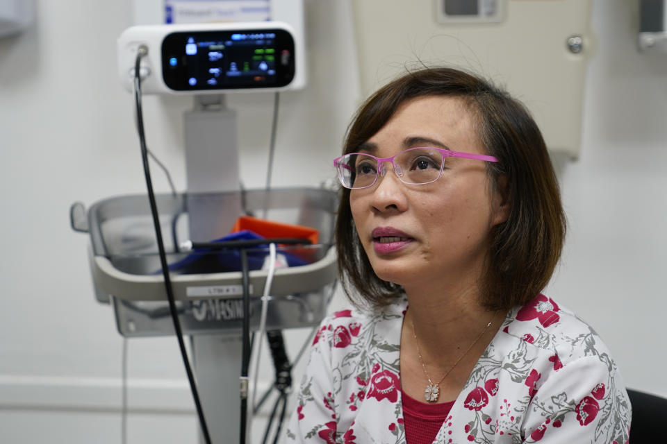 Clinical nurse Tram Pham becomes teary eyed remembering how hard it was at first, adjusting to life in the U.S. as a refugee from Vietnam at the Valley Health Center TB/Refugee Program in San Jose, Calif., on Dec. 9, 2021. Nearly three decades later, Pham is paying that comfort forward as a registered nurse at the same San Francisco Bay Area clinic that treated her family. The TB and Refugee Clinic at Santa Clara Valley Medical Center has started screening people from Afghanistan as part of the largest U.S. refugee resettlement effort in decades following the Aug. 30 withdrawal of troops from the country. (AP Photo/Eric Risberg)