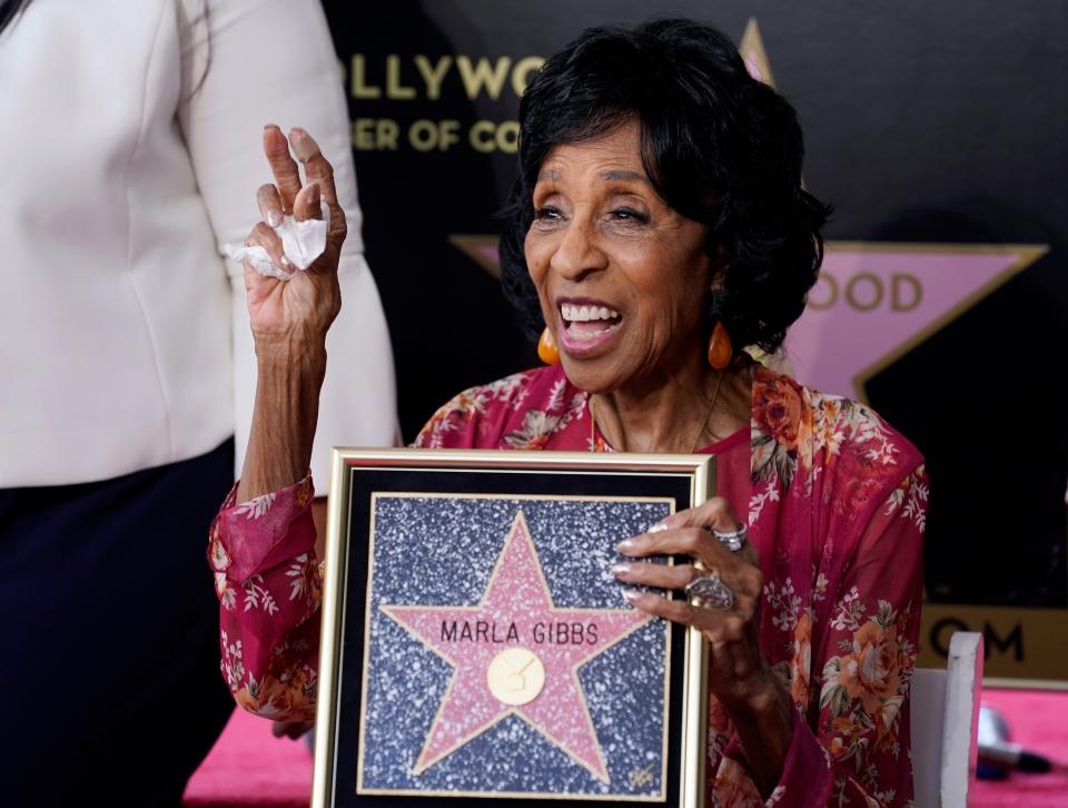 Actress Marla Gibbs celebrates with a replicator's of her new star on the Hollywood Walk of Fame following a ceremony for her, Tuesday, July 20, 2021, in Los Angeles.