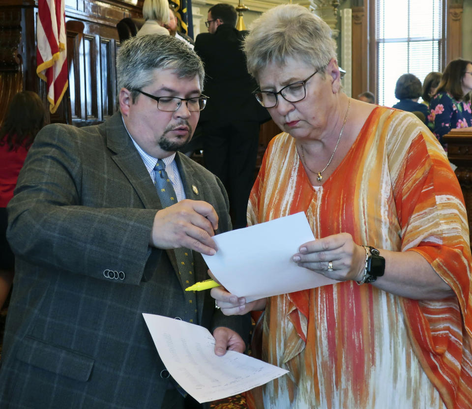 Kansas state Reps. Kyle Hoffman, left, R-Coldwater, and Brenda Landwehr, R-Wichita, review a tally of the House vote against a proposed $18.4 billion budget, Friday, May 3, 2019, at the Statehouse in Topeka, Kan. The budget narrowly failed because Democrats and moderate Republicans wanted to block it in hopes of forcing a Senate vote on Medicaid expansion. (AP Photo/John Hanna)