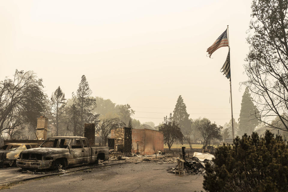 A U.S. flag flies at a burnt home in a neighborhood destroyed by wildfire on Sept. 13 in Talent, OR<span class="copyright">David Ryder—Getty Images</span>
