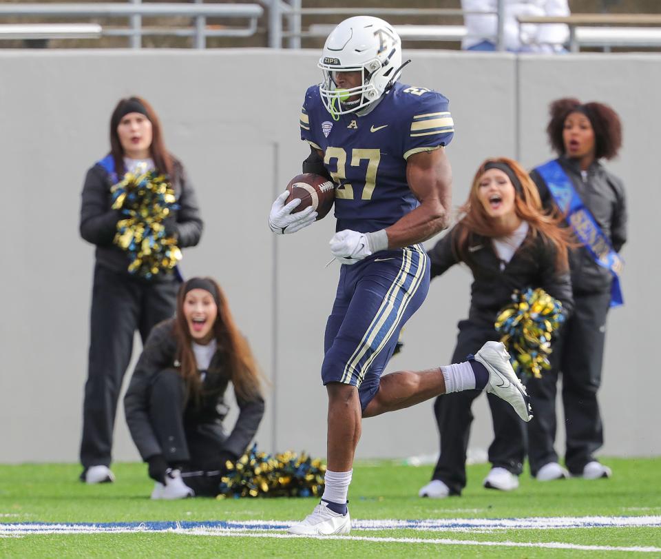 University of Akron running back Lorenzo Lingard scores a touchdown against Ohio on Friday, Nov. 24, 2023.