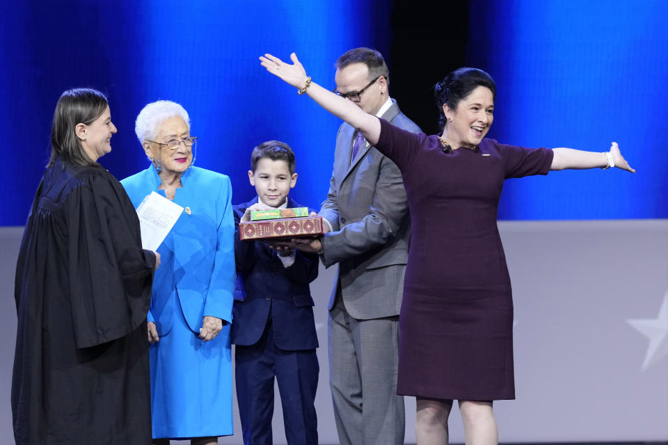 Illinois Comptroller Susana A. Mendoza acknowledges the crowd before taking the oath of office from Rossana P. Fernandez, Cook County Circuit Judge as her mother Susana, son David and husband David Szostak watch during ceremonies Monday, Jan. 9, 2023, in Springfield, Ill. (AP Photo/Charles Rex Arbogast)