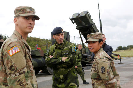 Supreme Commander of the Swedish Armed Forces, Micael Byden, talks with U.S. soldiers during the exercise 'Aurora 17' at Save airfield in Goteborg, Sweden. Henrik Brunnsgard/TT News Agency/via REUTERS