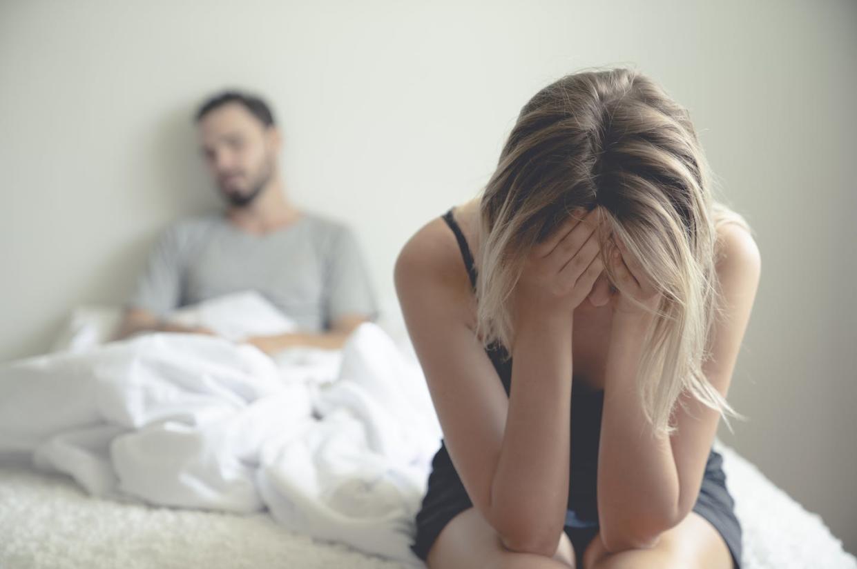 <span class="caption">Social distancing is challenging couples in an unprecedented way.</span> <span class="attribution"><a class="link " href="https://www.gettyimages.com/detail/photo/frustrated-sad-girlfriend-sit-on-bed-think-of-royalty-free-image/1144827480?adppopup=true" rel="nofollow noopener" target="_blank" data-ylk="slk:Witthaya Prasongsin/Moment via Getty Images;elm:context_link;itc:0;sec:content-canvas">Witthaya Prasongsin/Moment via Getty Images</a></span>