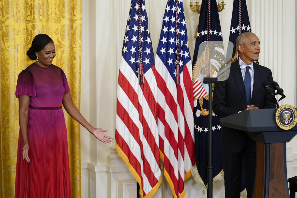 Former first lady Michelle Obama reacts as former President Barack Obama speaks during a ceremony in the East Room of the White House, Wednesday, Sept. 7, 2022, in Washington. The Obama's unveiled their official White House portraits during the ceremony. (AP Photo/Andrew Harnik)