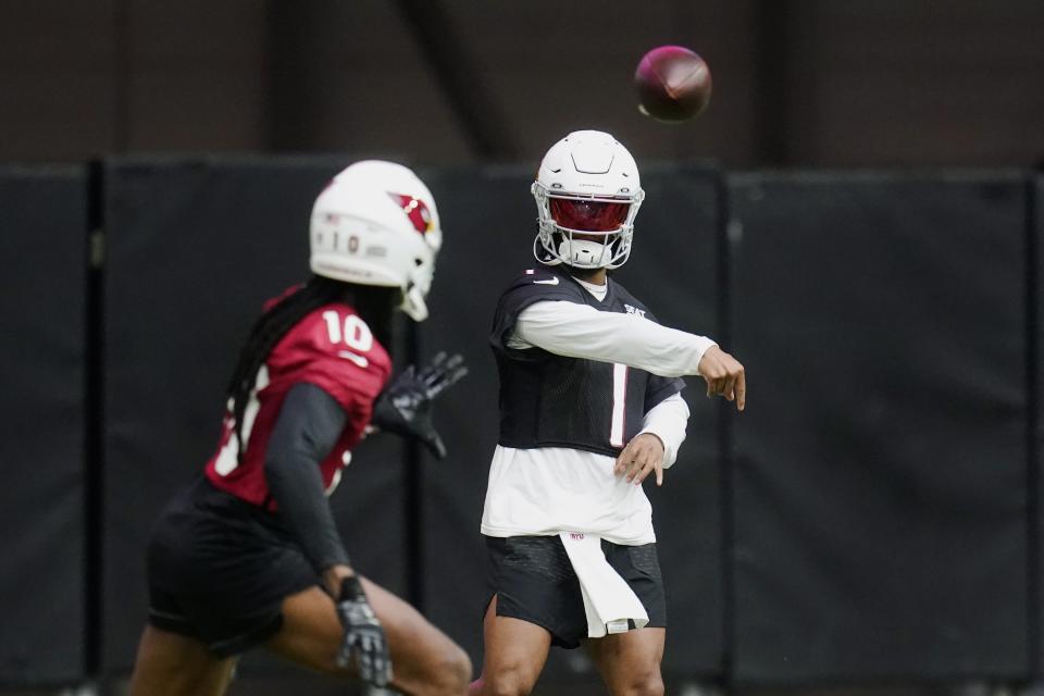 Arizona Cardinals quarterback Kyler Murray (1) throws a pass to wide receiver DeAndre Hopkins (10) as they take part in drills during the NFL football team's training camp at State Farm Stadium, Wednesday, July 27, 2022, in Glendale, Ariz. (AP Photo/Ross D. Franklin)