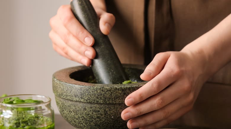 hands holding mortar and pestle