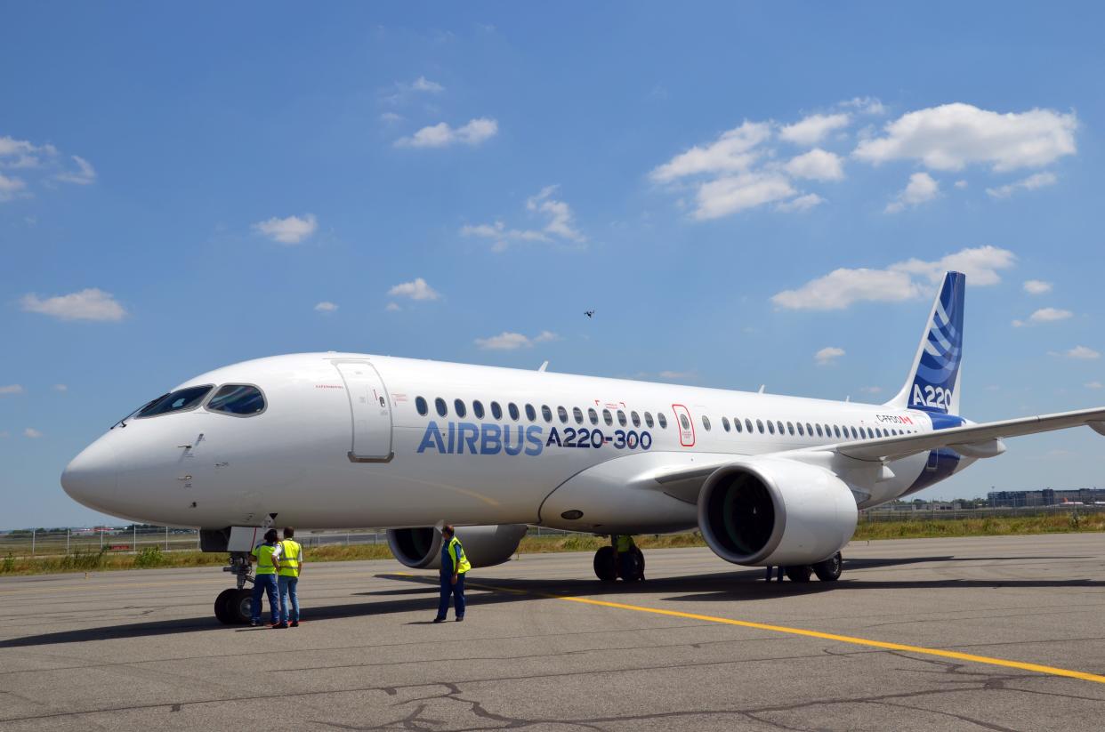 An aircraft of the model A220 is on the runway at the Airbus delivery centre near Toulouse.