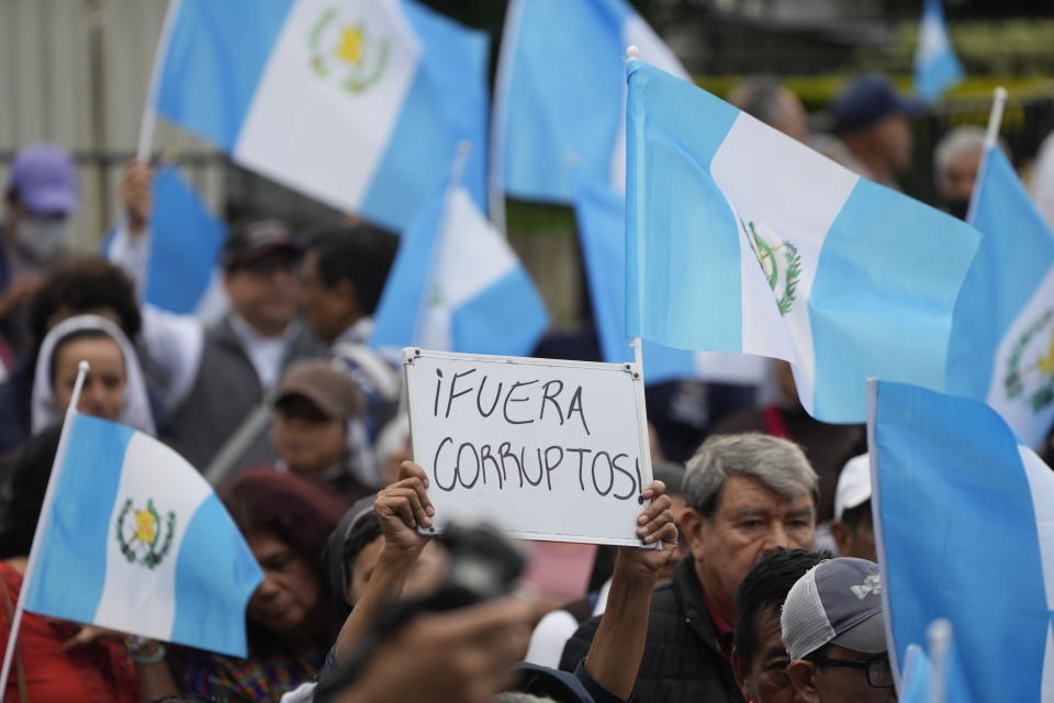 Un manifestante con una pizarra con un mensaje contra la corrupción en una marcha para exigir la renuncia de la fiscal general de Guatemala, Consuelo Porras, en Ciudad de Guatemala, el lunes 18 de septiembre de 2023. El presidente electo de Guatemala, Bernardo Arévalo, llamó a los guatemaltecos a protestar en las calles ante los intentos de obstaculizar su presidencia y para pedir la renuncia de la fiscal general. (AP Foto/Moisés Castillo)