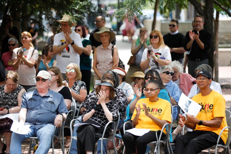 A group of Episcopal priests from across Missouri gather at Springfield's Park Central Square during a Juneteenth pilgrimage to pay respectsat the historical marker for lynching victims Fred Coker, Horace Duncan, and William Allen.