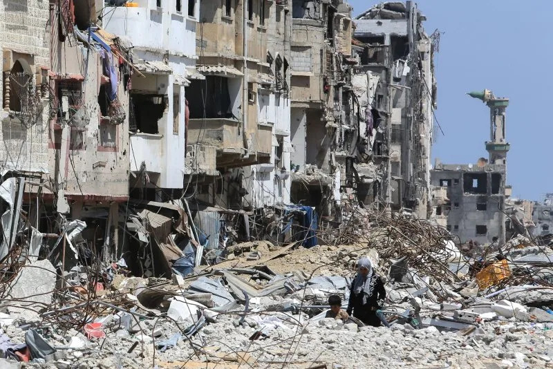 Palestinians endeavor to salvage usable items from the rubble-strewn streets and buildings following months of Israeli bombardment, in Khan Yunis, Gaza, on Saturday on April 13, 2024. Photo by Ismael Mohamad/UPI.