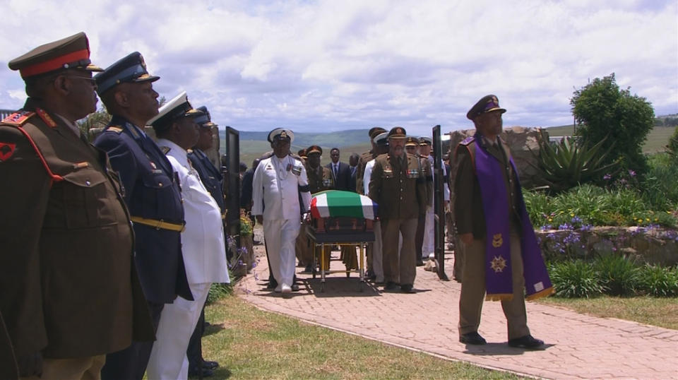 Military personnel carry coffin of former South African President Mandela towards his burial site in ancestral village of Qunuin