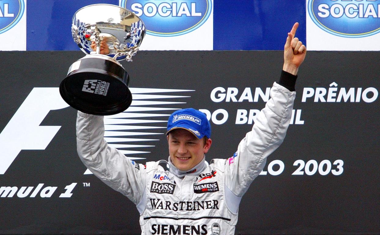 Finnish Formula One driver Kimi Raikkonen of McLaren-Mercedes holds the trophy after winning the Brazilian F1 GP, 06 April 2003, at Interlagos race track, in Sao Paulo. Italian Giancarlo Fisichella of Jordan-Ford took the second place, while Spanish Fernando Alonso finished third.
AFP PHOTO/Mauricio LIMA (Photo by VANDERLEI ALMEIDA / AFP)        (Photo credit should read VANDERLEI ALMEIDA/AFP via Getty Images)