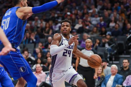 Mar 21, 2019; Sacramento, CA, USA; Sacramento Kings guard Buddy Hield (24) dribbles the ball around Dallas Mavericks center Salah Mejri (50) during the fourth quarter at Golden 1 Center. Mandatory Credit: Sergio Estrada-USA TODAY Sports