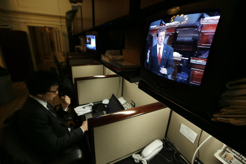 WASHINGTON, DC - MARCH 06:  U.S. Sen. Rand Paul (R-KY) is seen on a TV monitor participating in a filibuster on the Senate floor as Politco reporter Tim Mak works on his story at the Senate Press Gallery March 6, 2013 on Capitol Hill in Washington, DC. Sen. Paul was filibustering the Senate to oppose the nomination of John Brennan to be the next director of CIA.  (Photo by Alex Wong/Getty Images)
