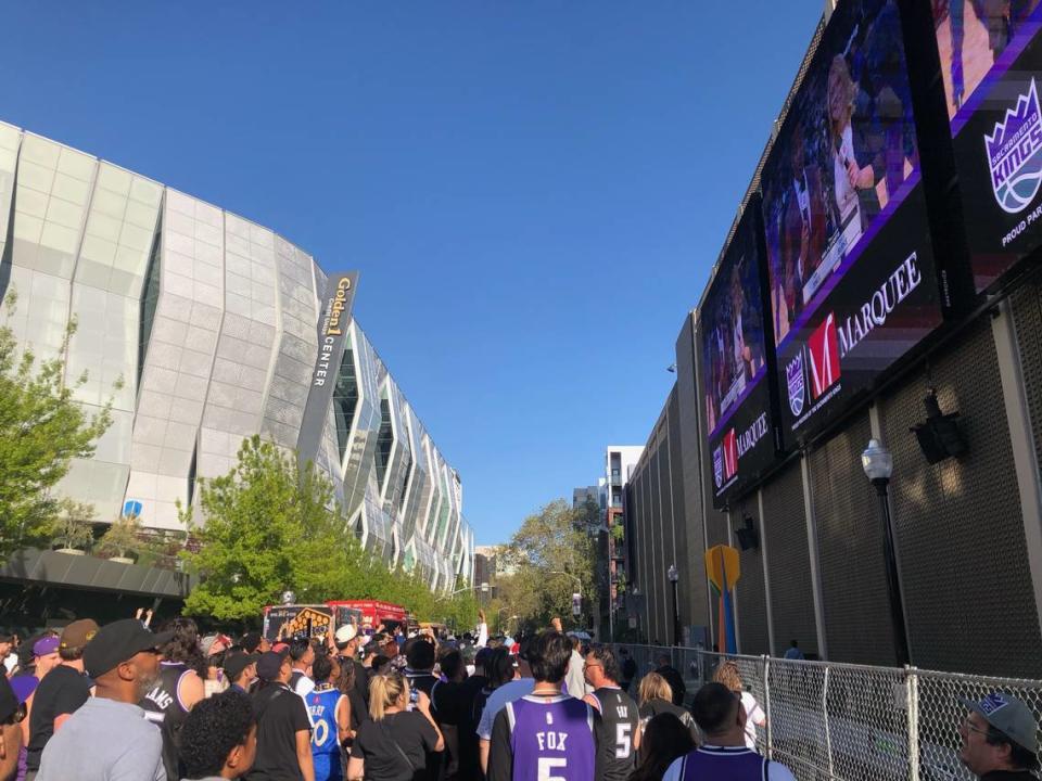 Sacramento Kings fans fill the Section 916 outdoor watch party on L Street in downtown Sacramento, where they can watch the game on large screens mounted on a parking garage, at the start of the team’s first game against the Golden State Warriors in the NBA playoff series on Saturday.