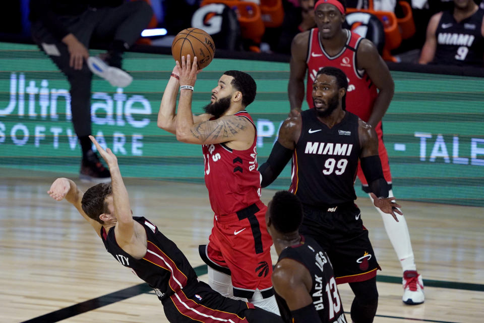 Toronto Raptors' Fred VanVleet (23) shoots as Miami Heat's Goran Dragic tries to draw the offensive foul during the second half of an NBA basketball game Monday, Aug. 3, 2020, in Lake Buena Vista, Fla. The Raptors won 107-103. (AP Photo/Ashley Landis, Pool)