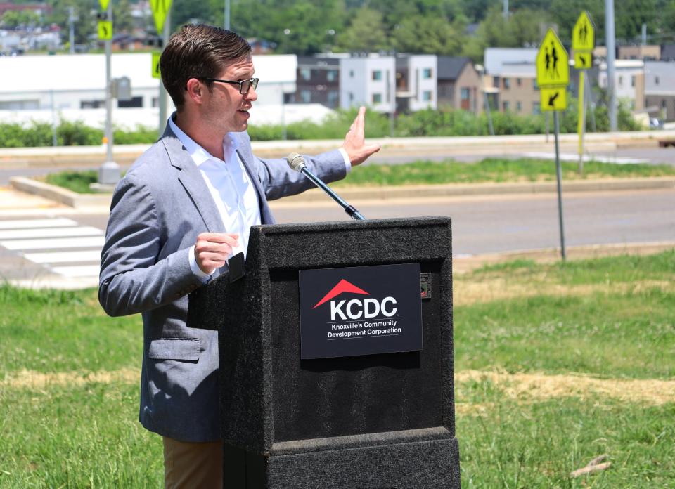 Knoxville’s Community Development Corporation Executive Director and CEO Ben Bentley gestures toward a new signalized crosswalk during its official opening ceremony May 19. The crosswalk is intended to improve safety for children living at the First Creek at Austin housing development who attend Green Magnet Academy and was developed through a partnership between KCDC and Bike Walk Knoxville. May 19, 2023