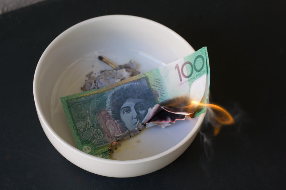 Money burning in a bowl