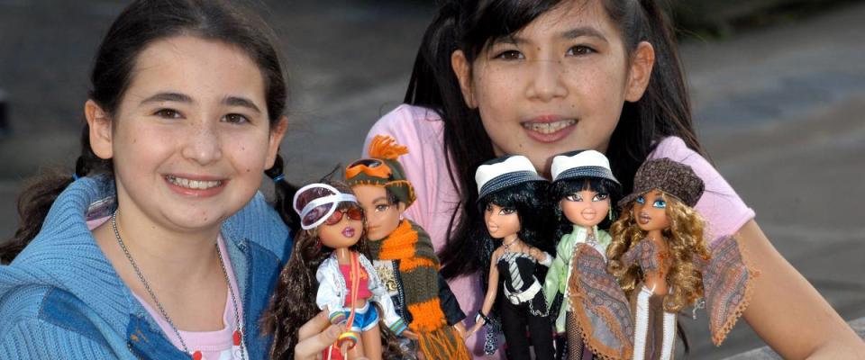 Two girls holding Bratz Dolls