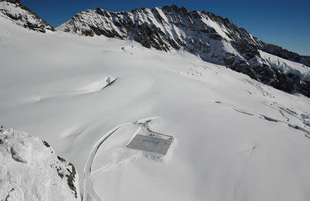 A general view shows 100,000 postcards with messages against climate change, sent by young people from all over the world and stuck together to break the Guinness World Record of the biggest postcard on the Jungfraufirn, the upper part of Europe's longest glacier, the Aletschgletscher, near Jungfraujoch, Switzerland November 16, 2018. REUTERS/Arnd Wiegmann