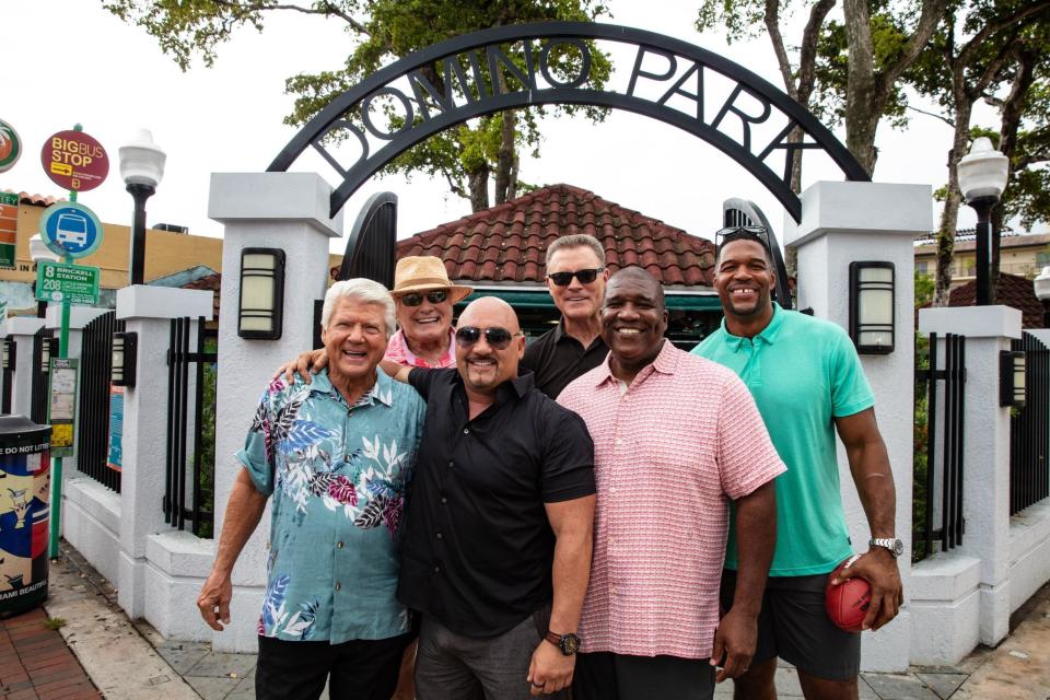 Jimmy Johnson, Terry Bradshaw, Jay Glazer, Howie Long, Curt Menefee and Michael Strahan, from left, pose in Domino Park in Miami on Aug. 23, 2019. The “Fox NFL Sunday” pregame show was inducted into the NAB Broadcasting Hall of Fame in April and starts its 26th season on Sunday, Sept. 8. (Fox Sports via AP)
