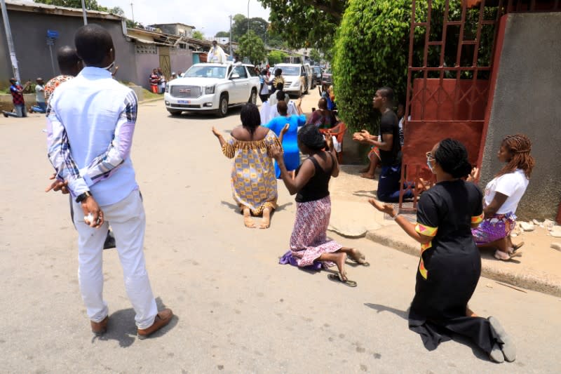 Abbe Abekan travels around the streets as he prays to stop the spread of coronavirus disease (COVID-19), in Abidjan