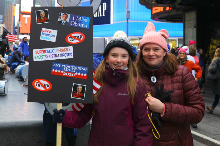 Karen Marron and her daughter Claire, 12, stand in Times Square at the end of the Women’s March. (Photo: Gordon Donovan/Yahoo News)