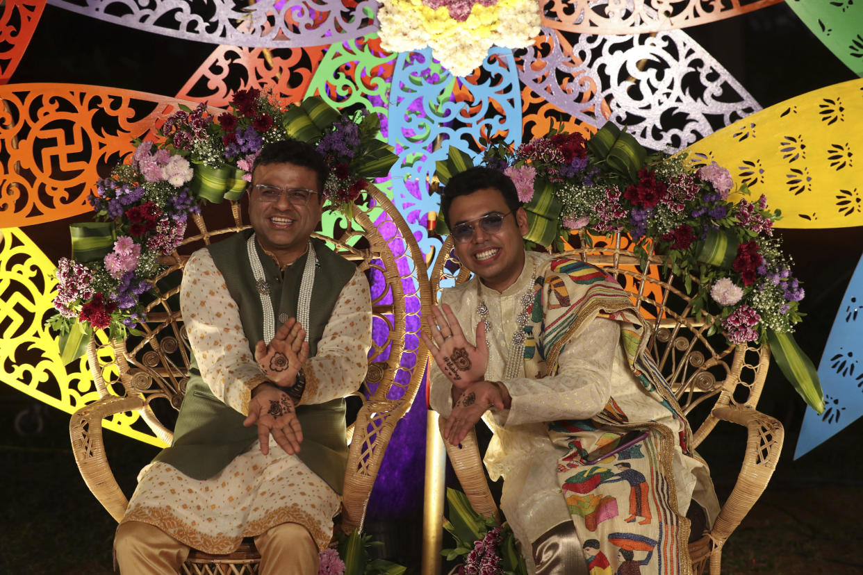 Indian gay couple Supriyo Chakraborty, right, and Abhay Dang, gesture during their pre-wedding ceremony on the outskirts of Hyderabad, India, Dec. 17, 2021. In a first for the southern Indian state of Telangana, the two men celebrated their same-sex union with a wedding ceremony. There is no law allowing same-sex marriage in India, so the couple were not able to register their marriage, but they told local media they wanted to find a way to celebrate and officially mark their relationship. / Credit: Mahesh Kumar A/AP