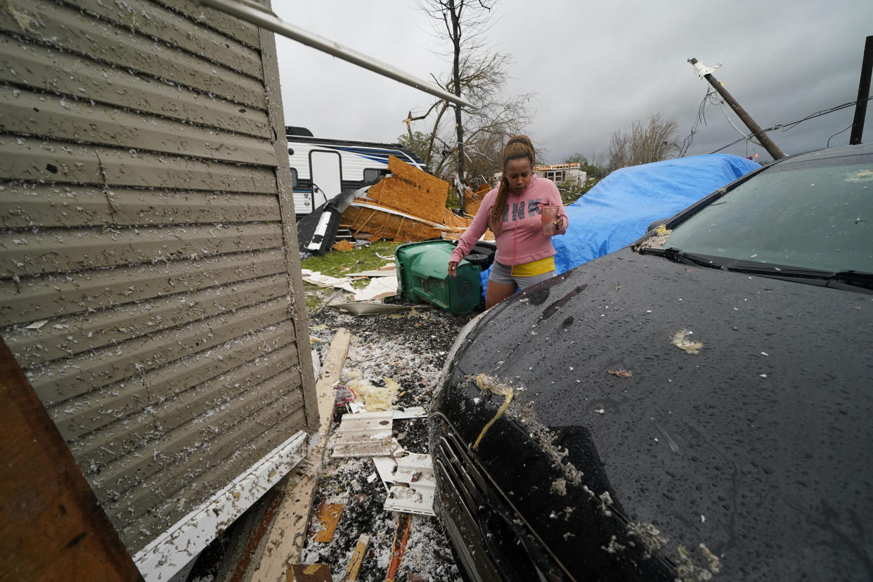 A person walks amid rubble after a tornado tore through the area in Killona, La., about 30 miles west of New Orleans in St. James Parish, Wednesday, Dec. 14, 2022. (AP Photo/Gerald Herbert)