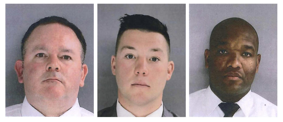 In this photo provided by the Delaware County District Attorney's Office on Tuesday, Jan. 18, 2022, Sharon Hill Police officers Brian Devaney, left, Sean Dolan, and Devon Smith are shown. The three police officers have been charged with manslaughter and reckless endangerment after firing their weapons into a crowd of people exiting a high school football game outside of Philadelphia, killing 8-year-old Fanta Bility and injuring three people. (Delaware County District Attorney's Office vis AP)