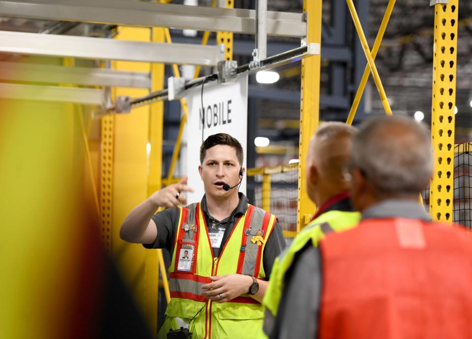 General Manager Anthony Papa leads a tour of the Amazon facility.