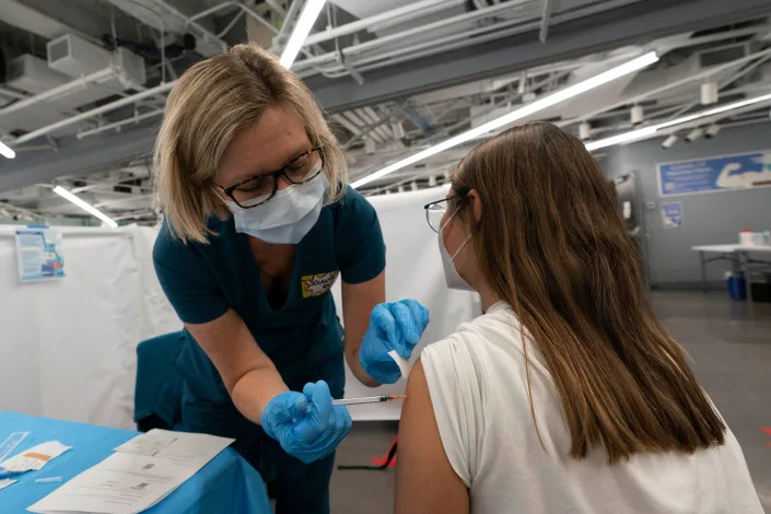 A New York woman receives a Pfizer COVID-19 vaccination.