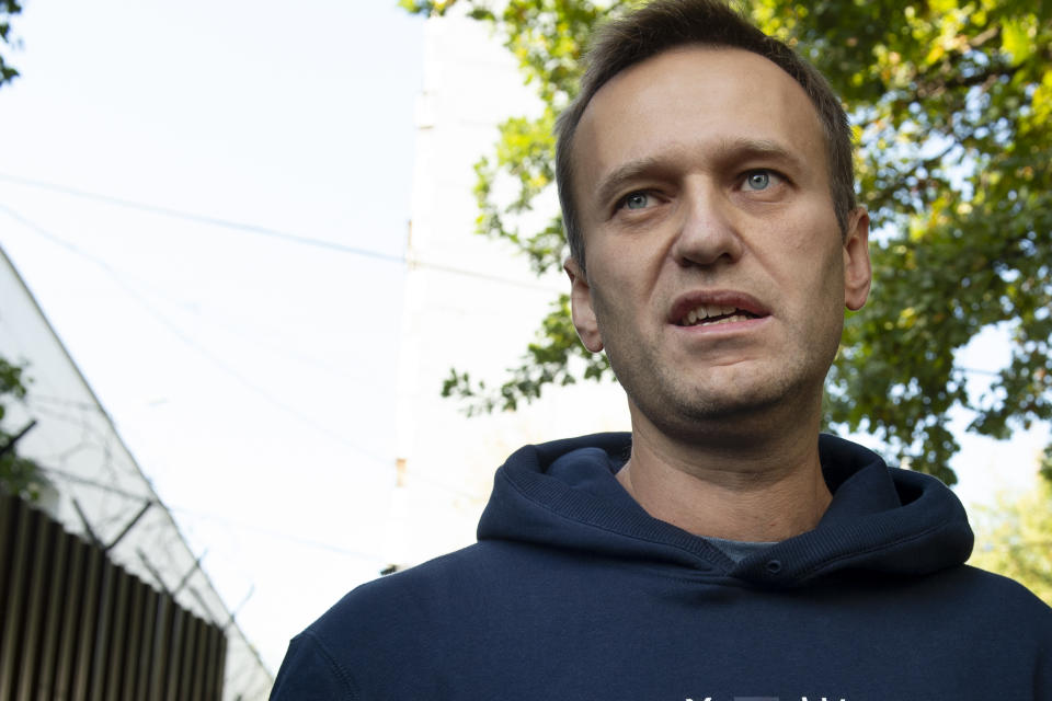 Russian opposition leader Alexei Navalny speaks to the media as he leaves a detention center after his release, in Moscow, Russia, Friday, Aug. 23, 2019. Navalny, the Kremlin's most prominent foe, was sentenced last month to 30 days for calling on people to take part in an unauthorized protest. (AP Photo/Dmitry Serebryakov)