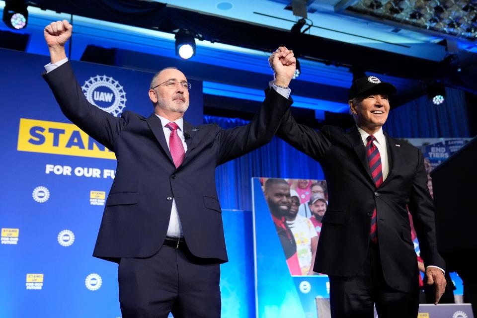 President Joe Biden stands with Shawn Fain, President of the United Auto Workers, at the United Auto Workers' political convention, Wednesday, Jan. 24, 2024, in Washington.